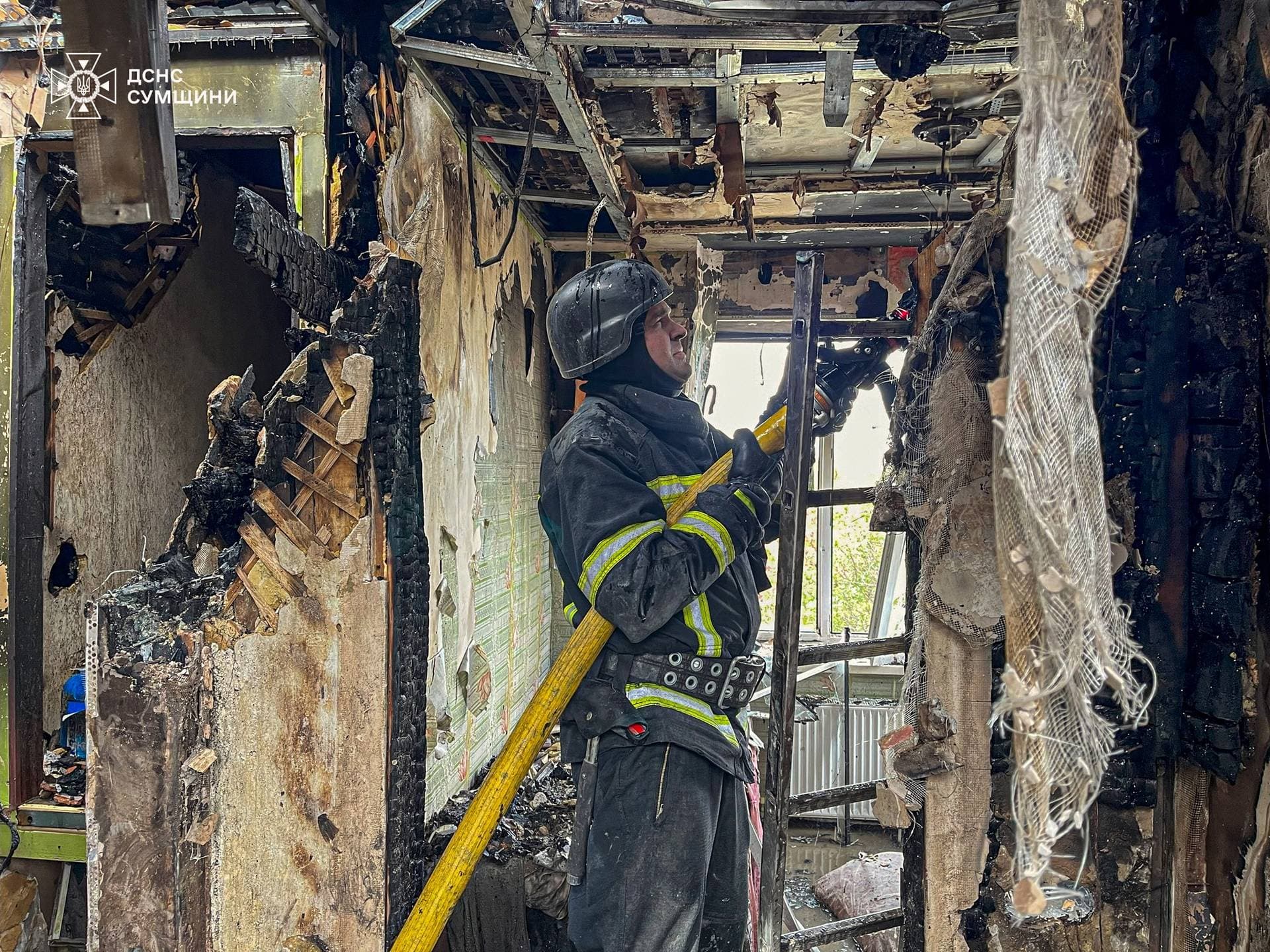 A firefighter works at the site of a Russian drone strike in Sumy Region