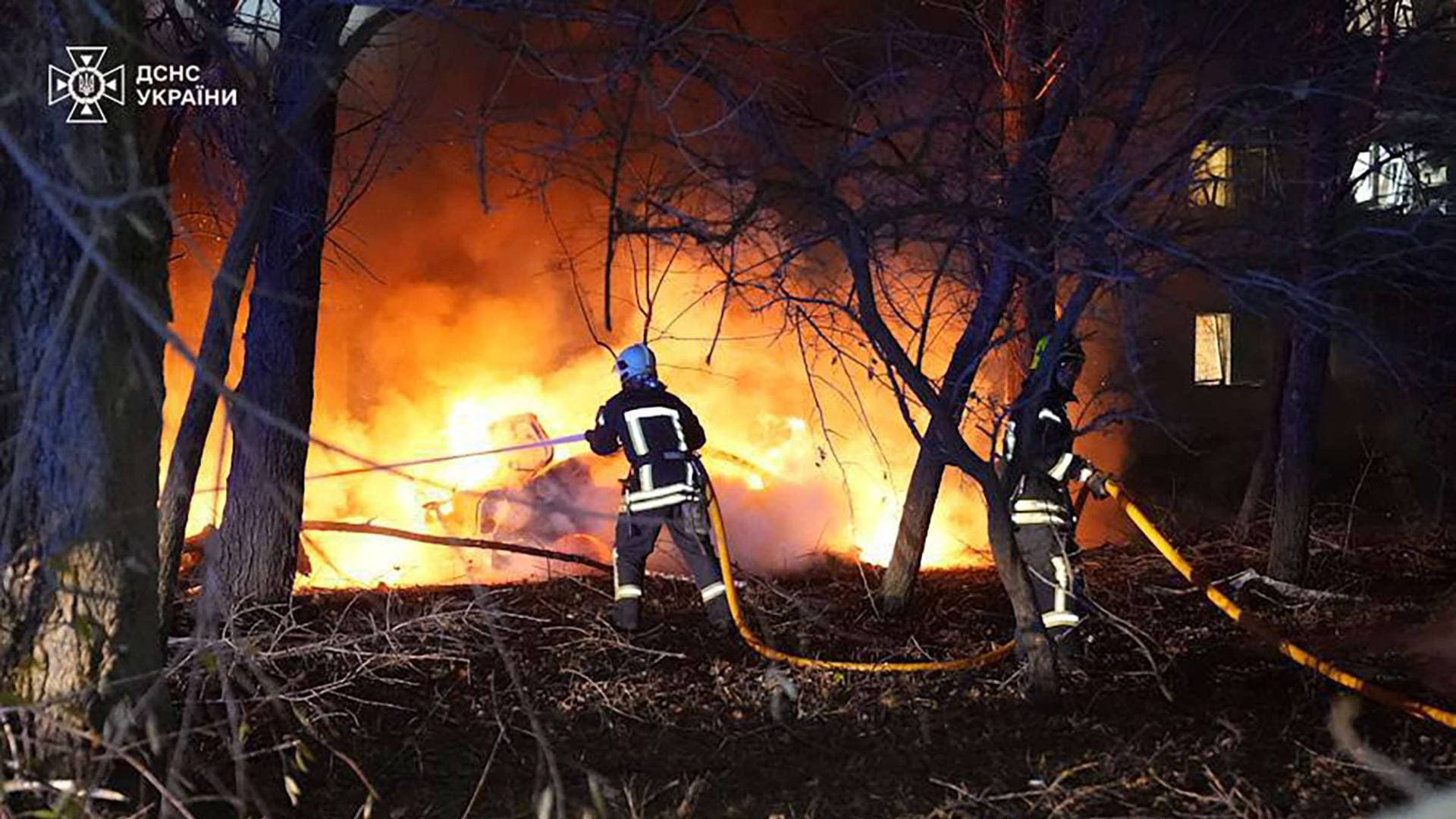 Firefighters work at the site of a residential area hit by a Russian missile strike in Sumy
