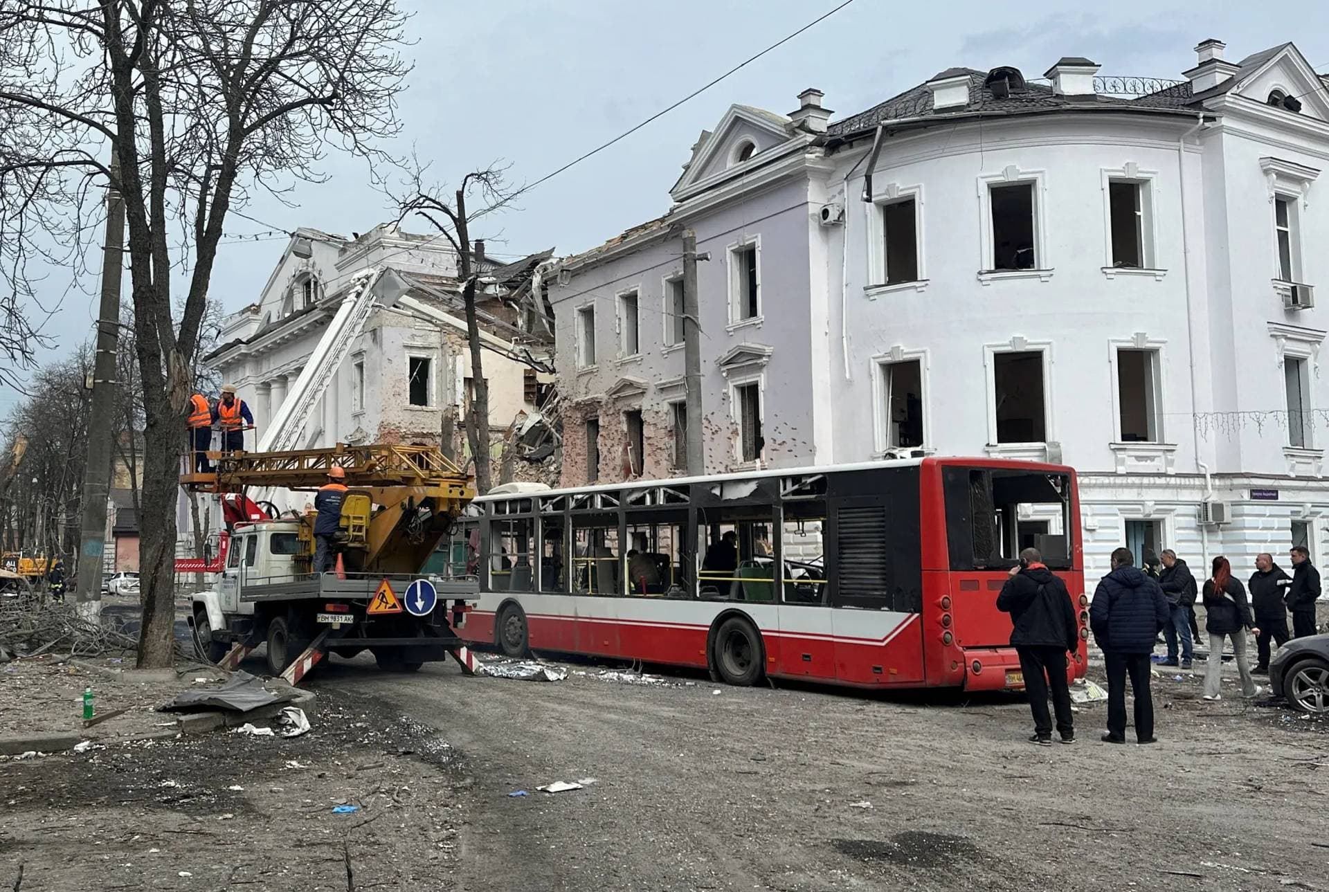 Members of emergency services work at the site of a Russian missile strike in Sumy