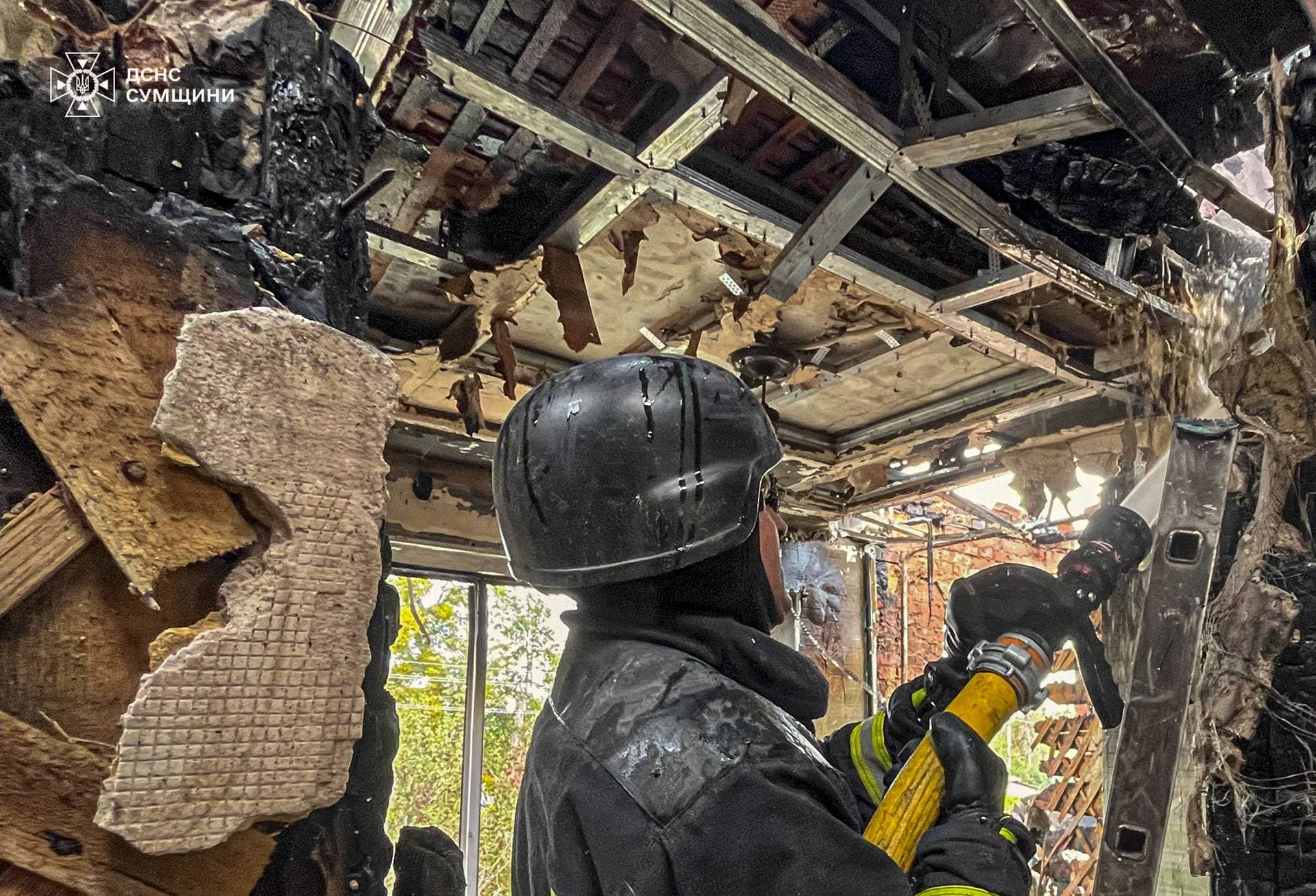 A firefighter works at the site of a Russian drone strike in Sumy Region