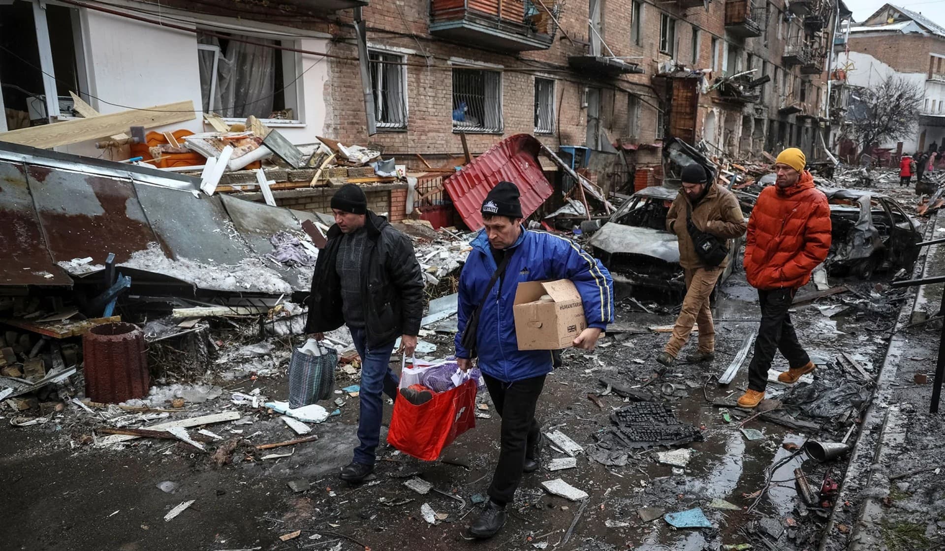 Local residents take things from their residential building destroyed by a Russian missile attack in the town of Vyshhorod